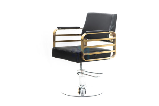 Black barber chair with gold armrests