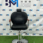 Black barber chair with wooden armrests