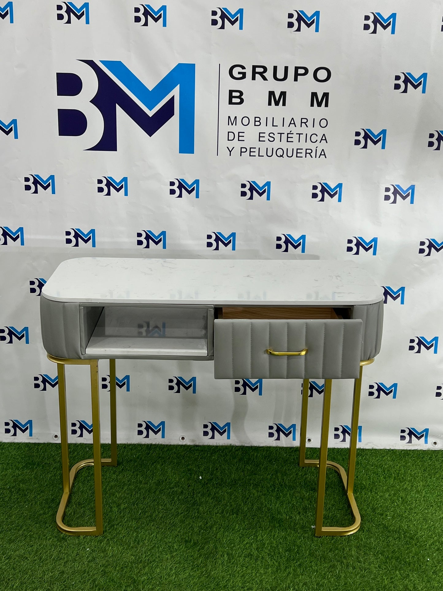 Individual manicure table in gray leatherette with marble-like stone and golden base